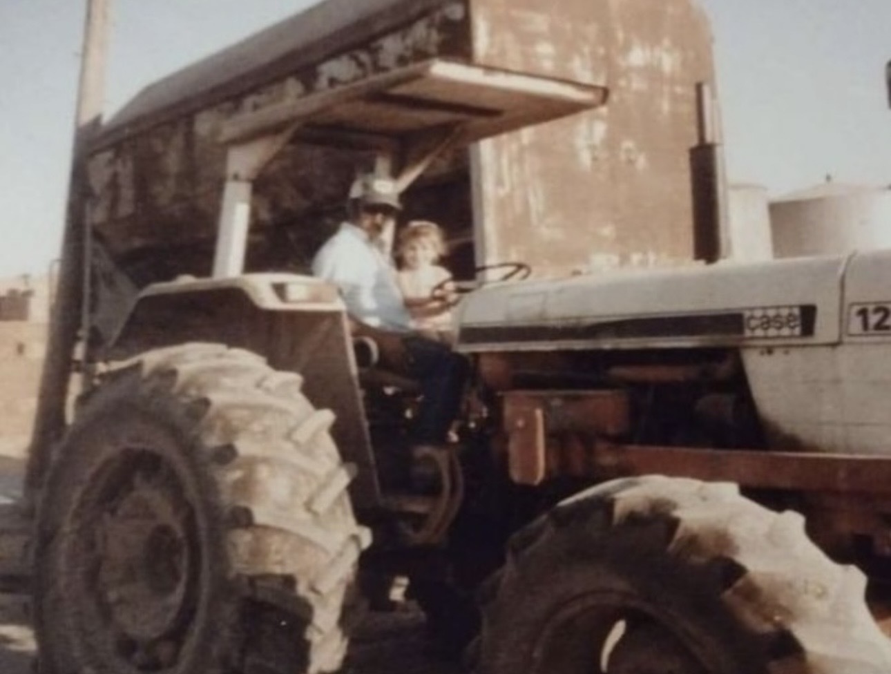 Ashlee with her grandpa on the family dairy farm