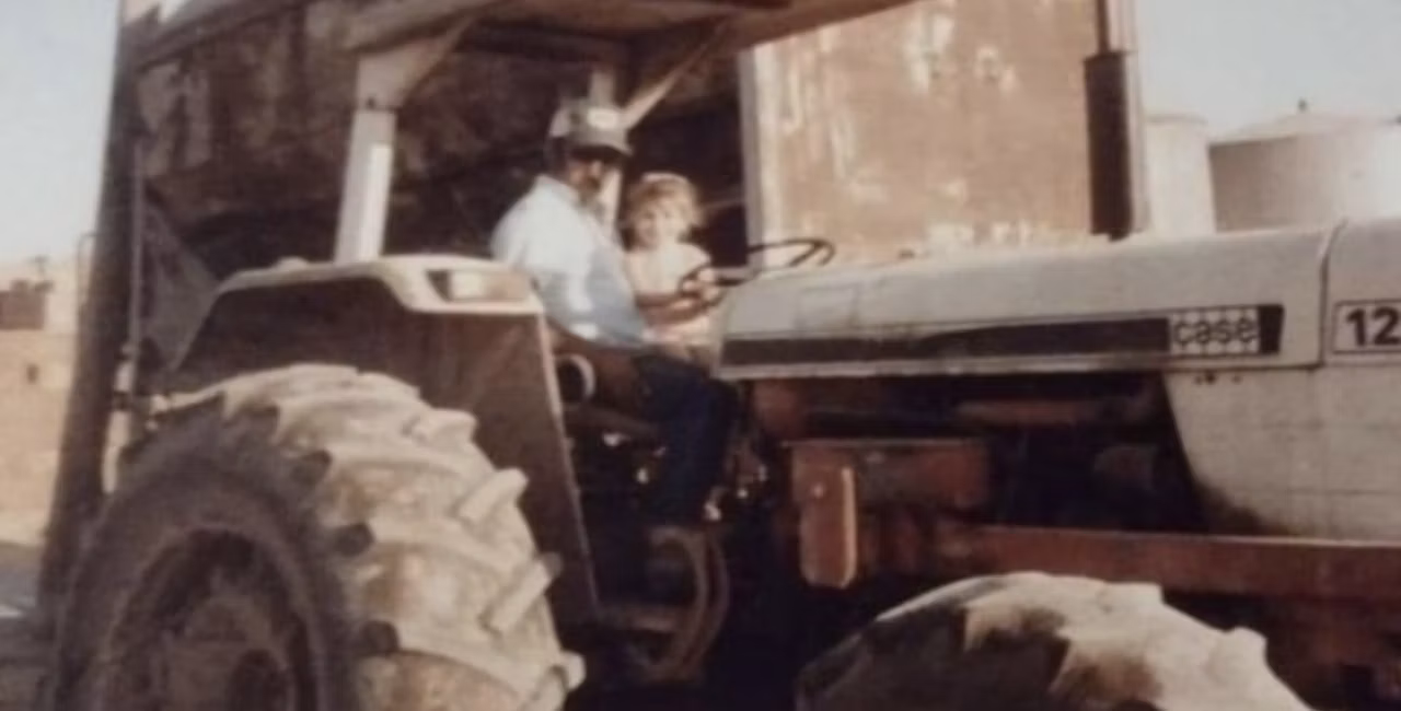 Ashlee with her grandpa on the family dairy farm