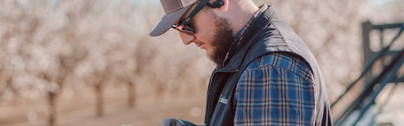 Semios field services technician installing a camera trap in the field