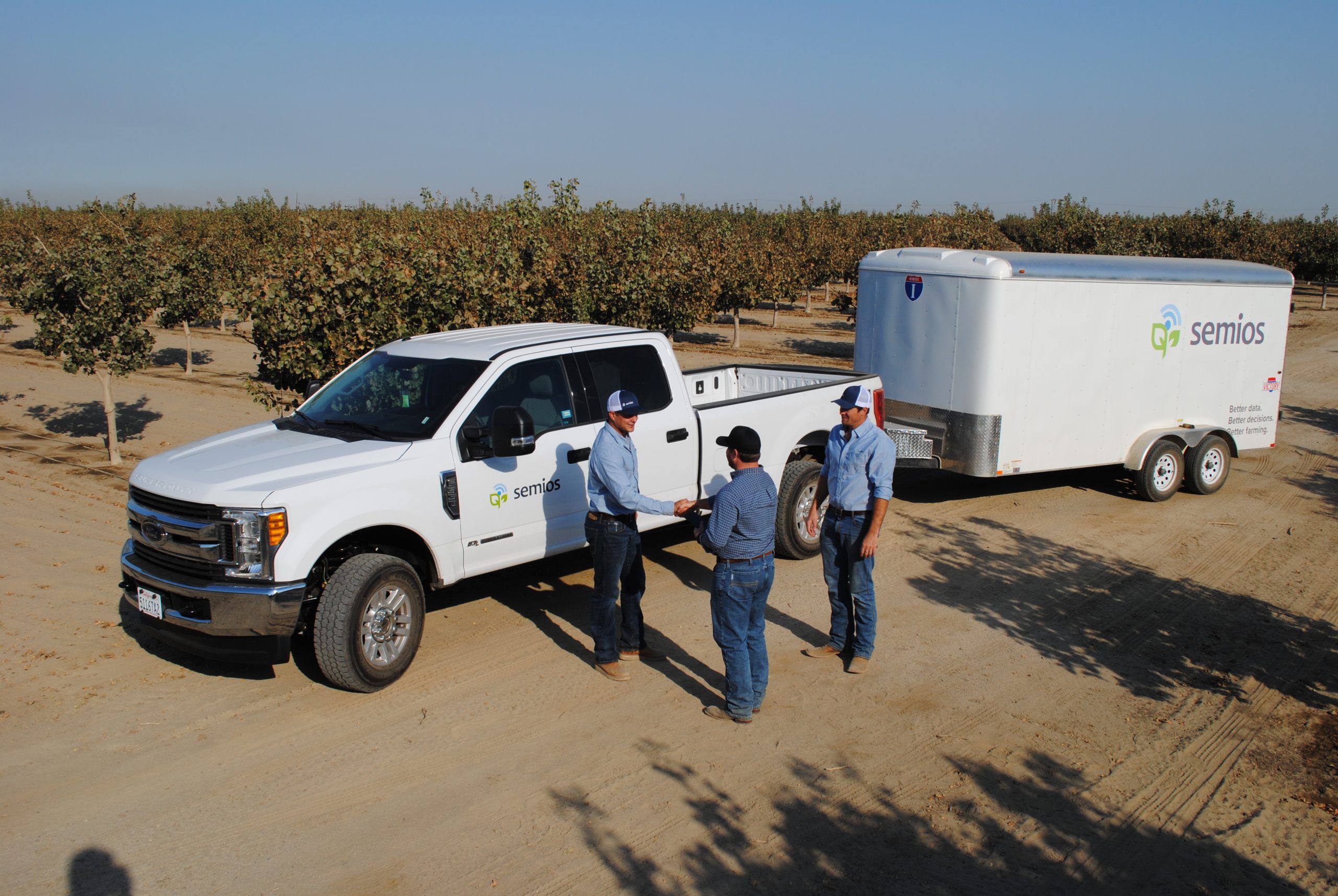 Semios team meeting with a client in the field