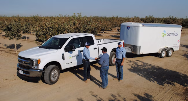 Semios team meeting with a client in the field