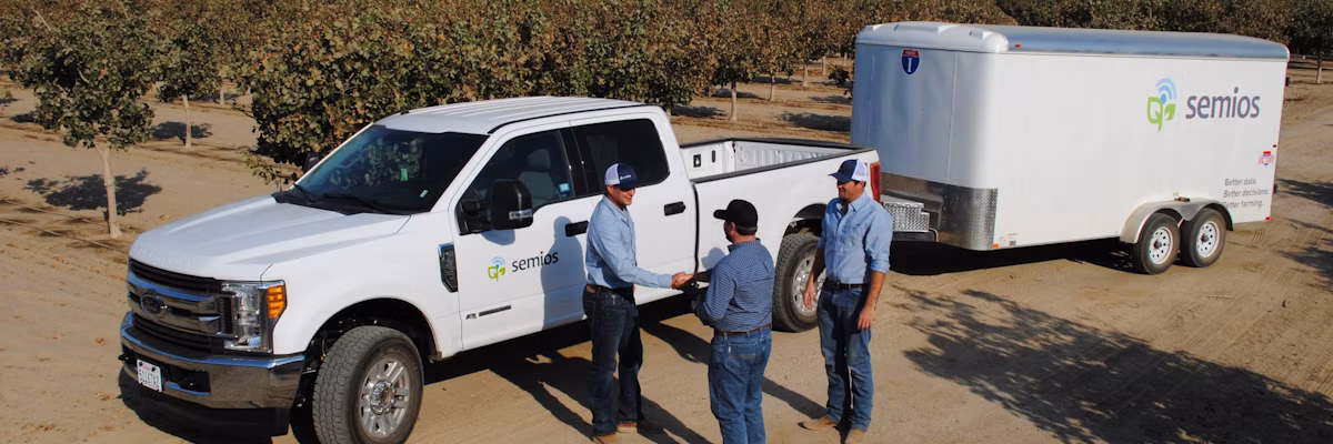 Semios team meeting with a client in the field