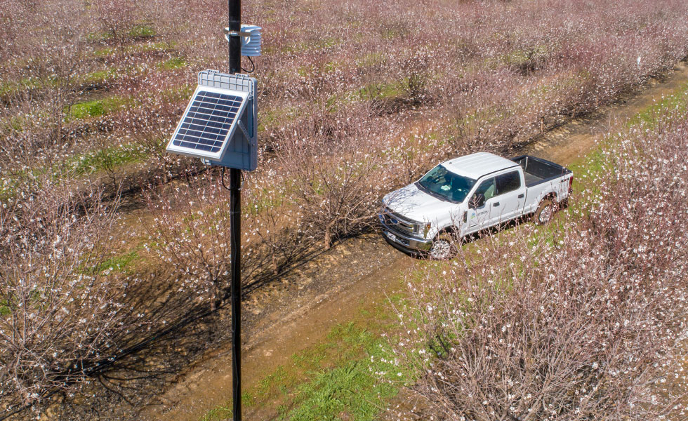 Semios service truck in the field of an almond orchard during bloom