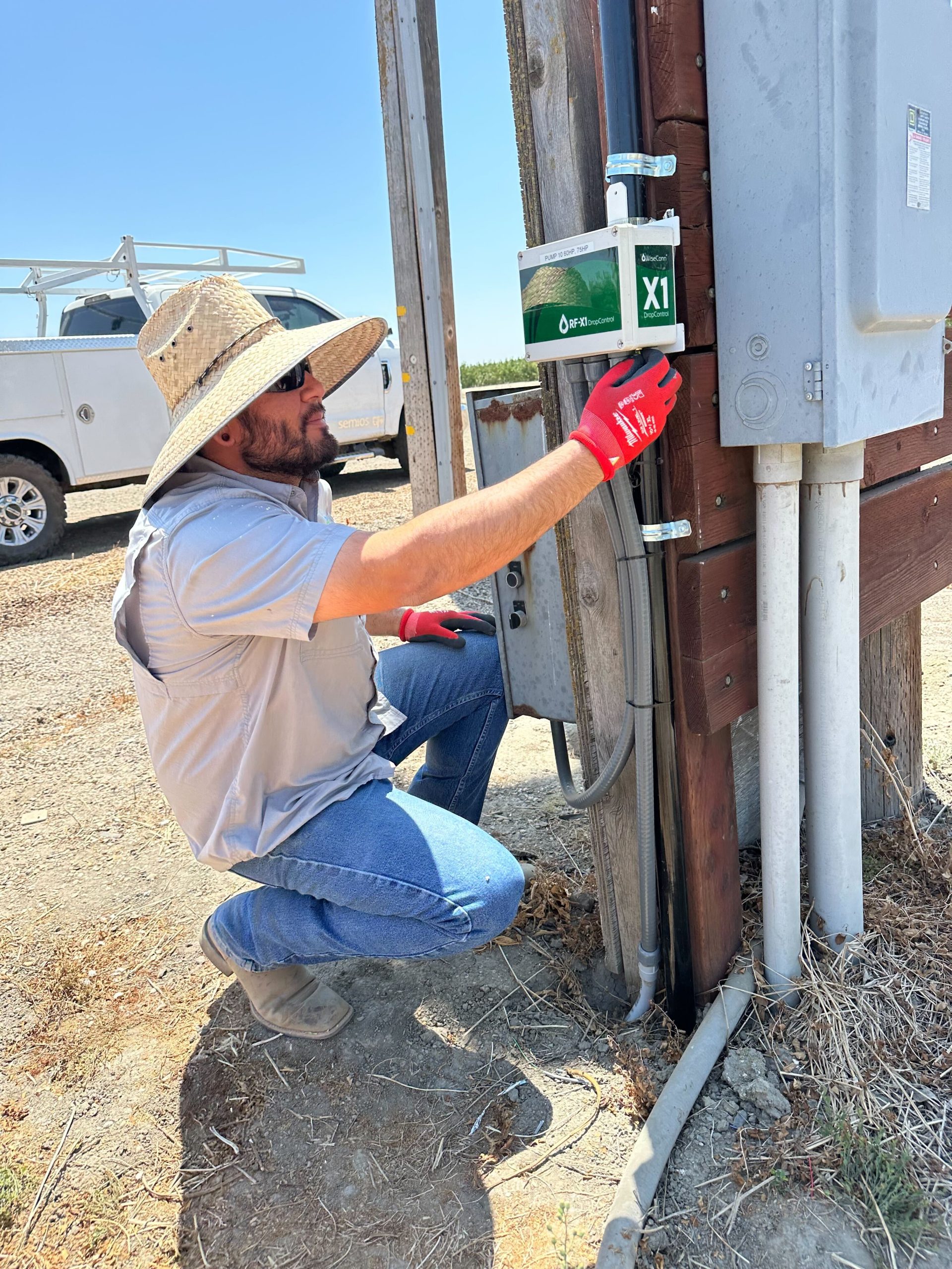 Semios field technician inspecting a WiseConn box