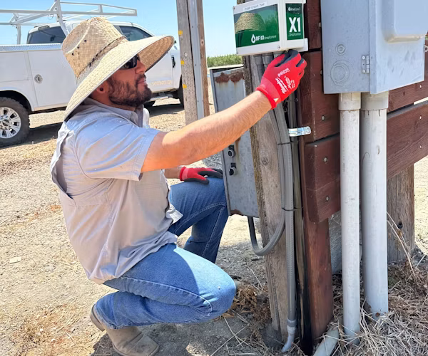 Semios field technician inspecting a WiseConn box