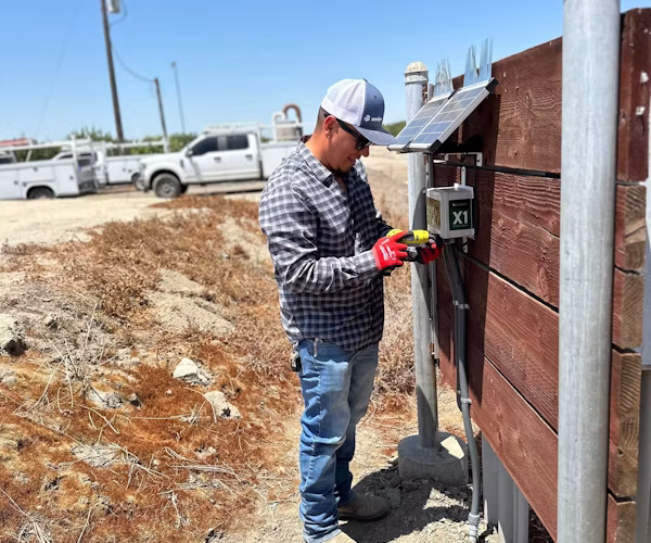 Semios field technician installing a WiseConn box