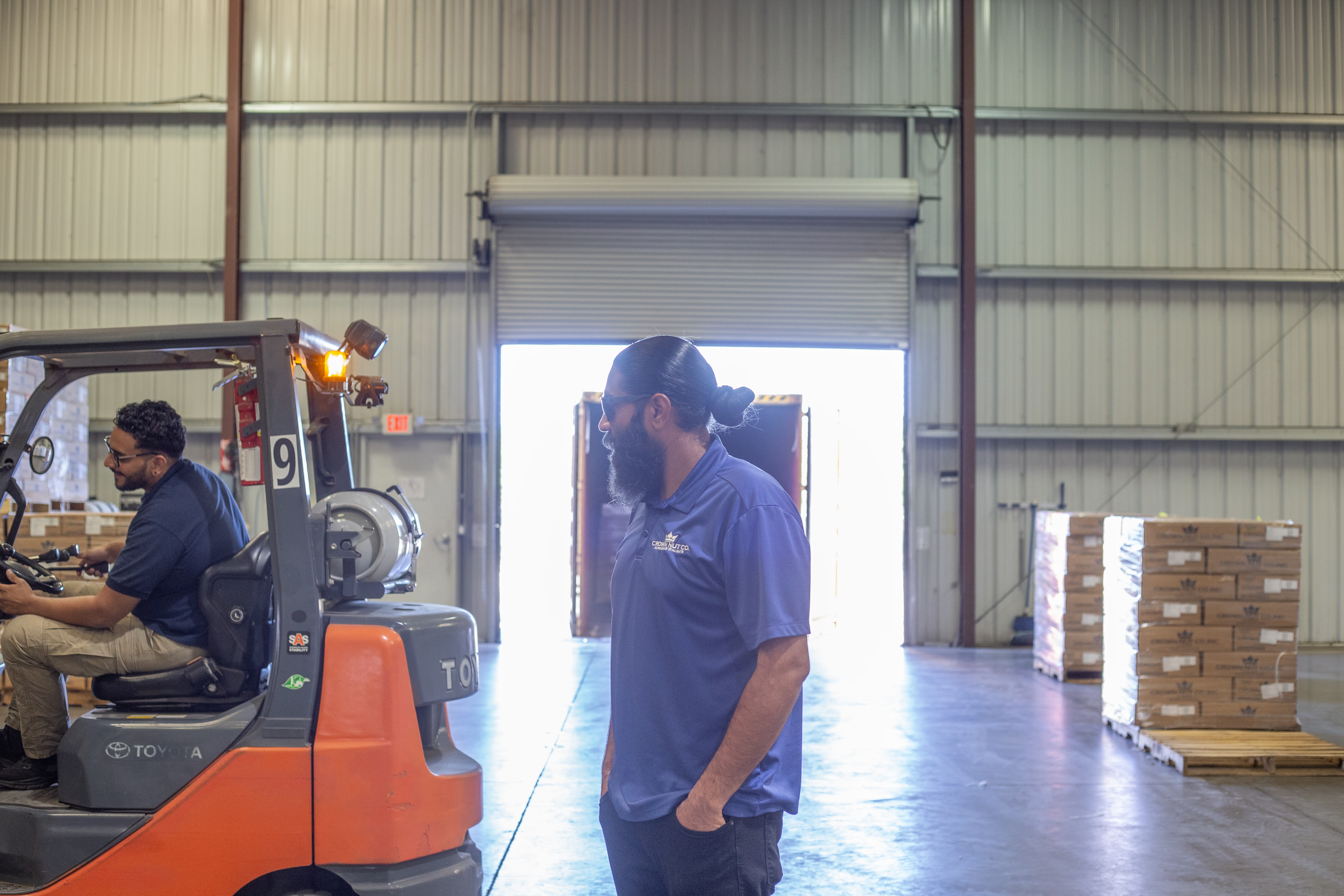 Aman Sandhu overseeing workers in the warehouse